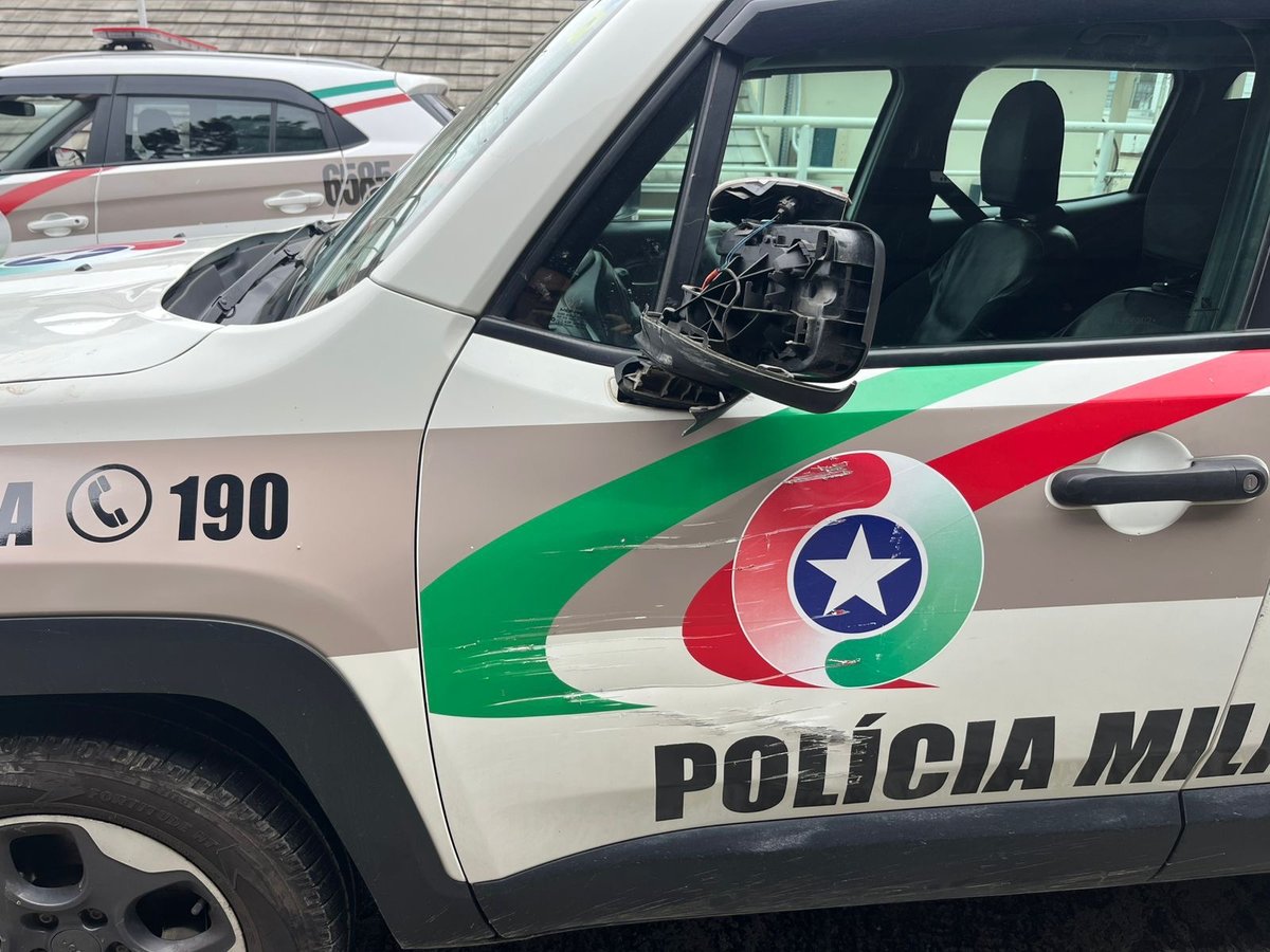 Lateral da viatura da PMSC com marcas e espelho quebrado